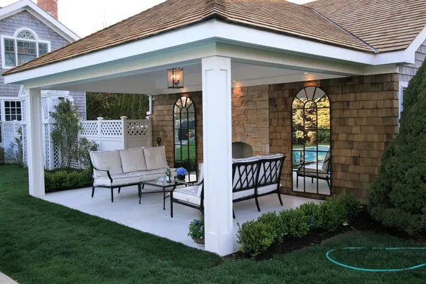 a view of a chair and table in backyard of the house