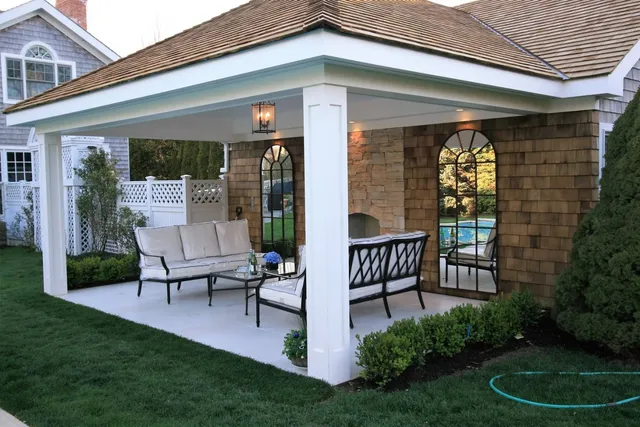 a view of a chair and table in backyard of the house