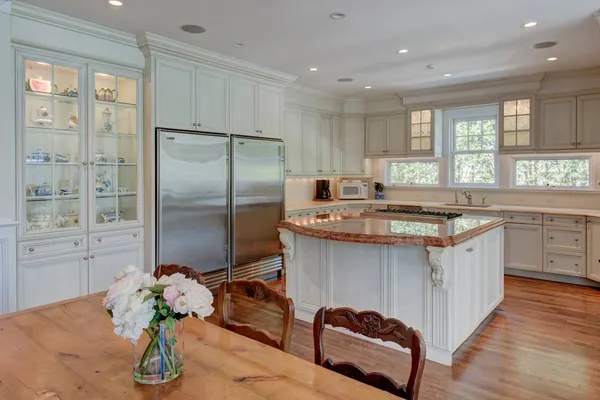 a kitchen with stainless steel appliances granite countertop a sink a stove and refrigerator