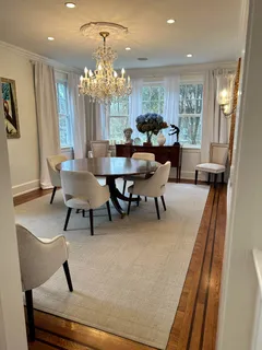 a view of a dining room with furniture and chandelier
