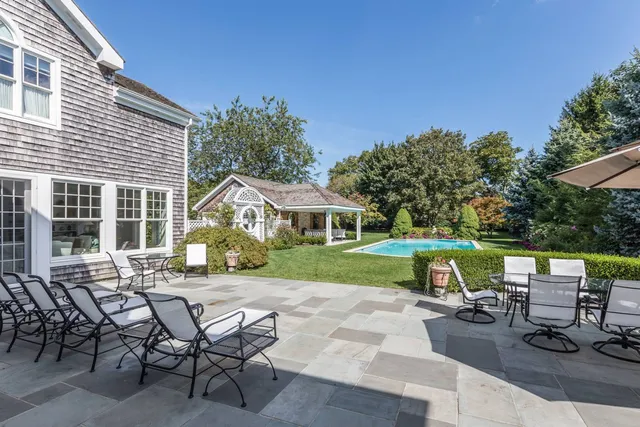 a view of a house with backyard sitting area and garden