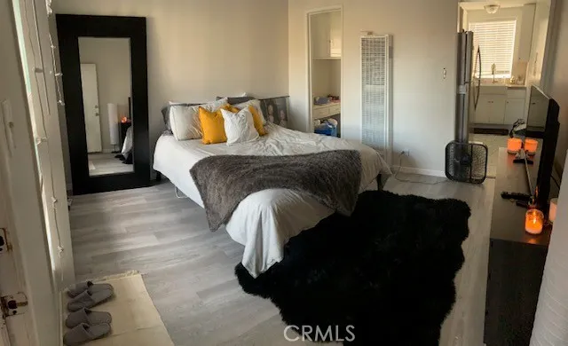 a bedroom with a bed and wooden floor