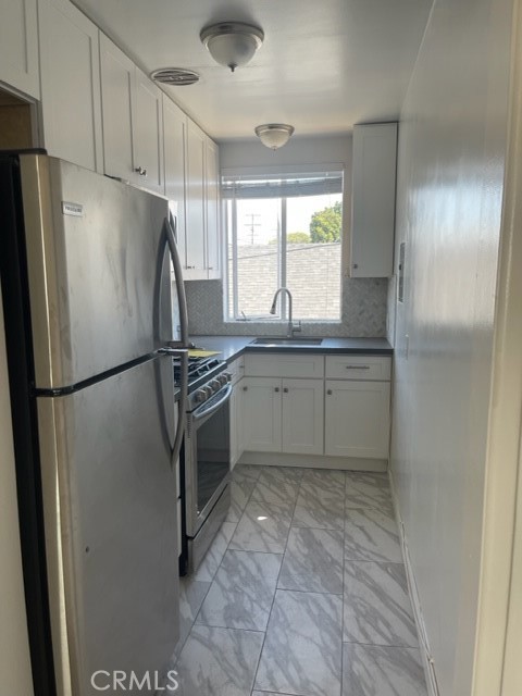 1809 East 4th Street, Unit 3 Long Beach, CA 90802 - Photo 4 of 10 a kitchen with stainless steel appliances granite countertop a refrigerator sink and cabinets