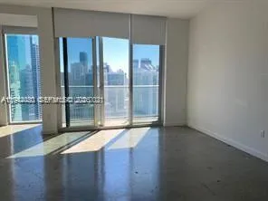 a view of an empty room with glass door