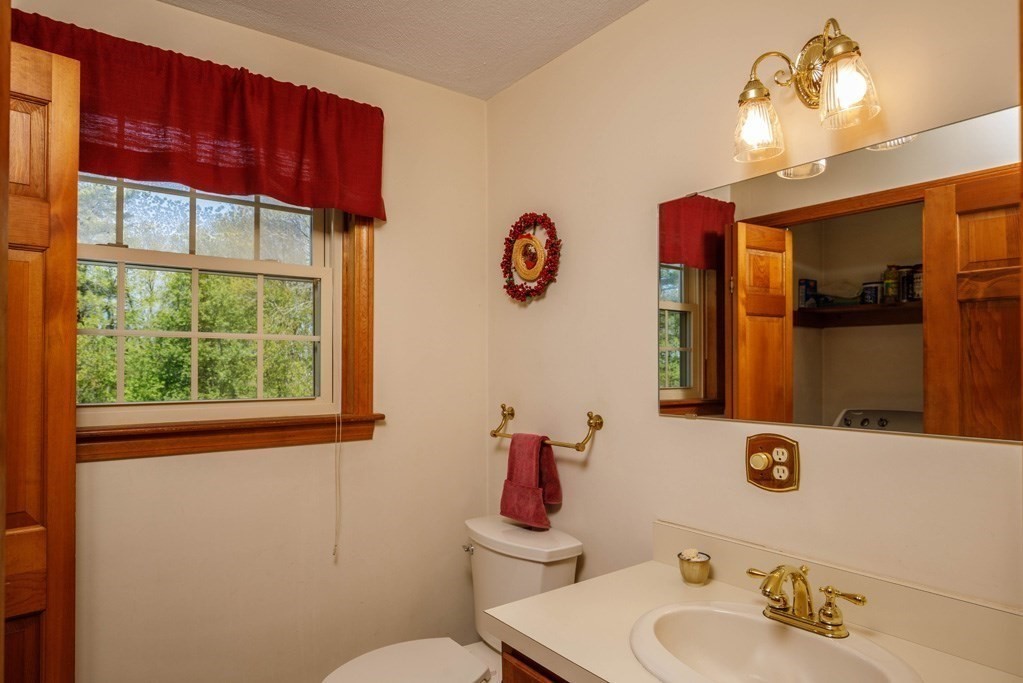202 Leo Drive Gardner, MA 01440 - Photo 12 of 26 a bathroom with a sink vanity mirror and toilet
