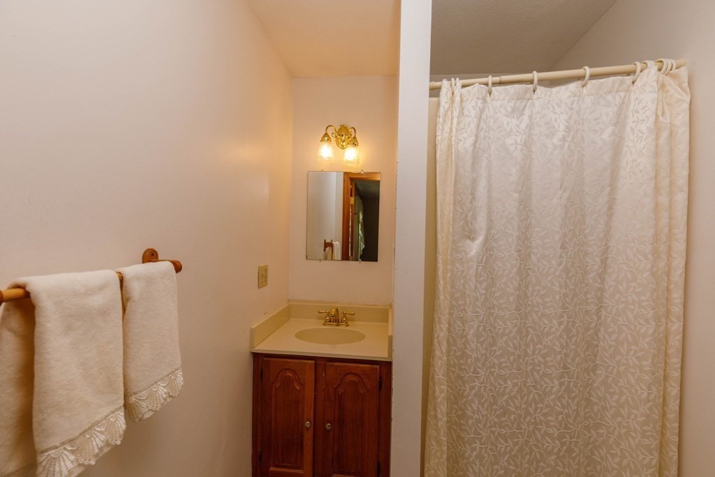 202 Leo Drive Gardner, MA 01440 - Photo 15 of 26 a bathroom with a shower curtain and a sink