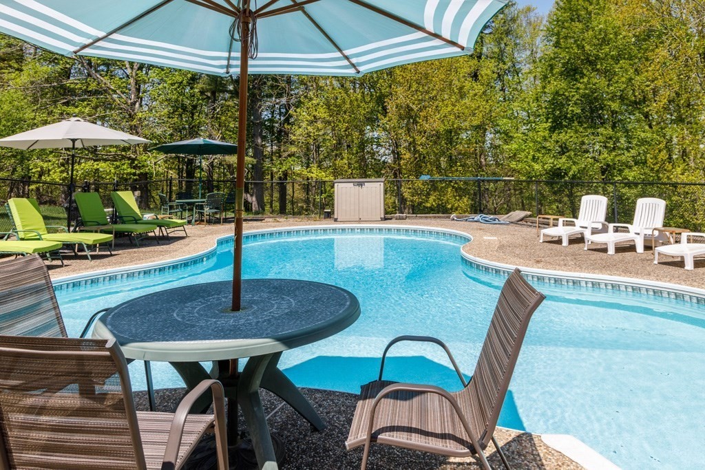 202 Leo Drive Gardner, MA 01440 - Photo 3 of 26 a roof deck with table and chairs under an umbrella