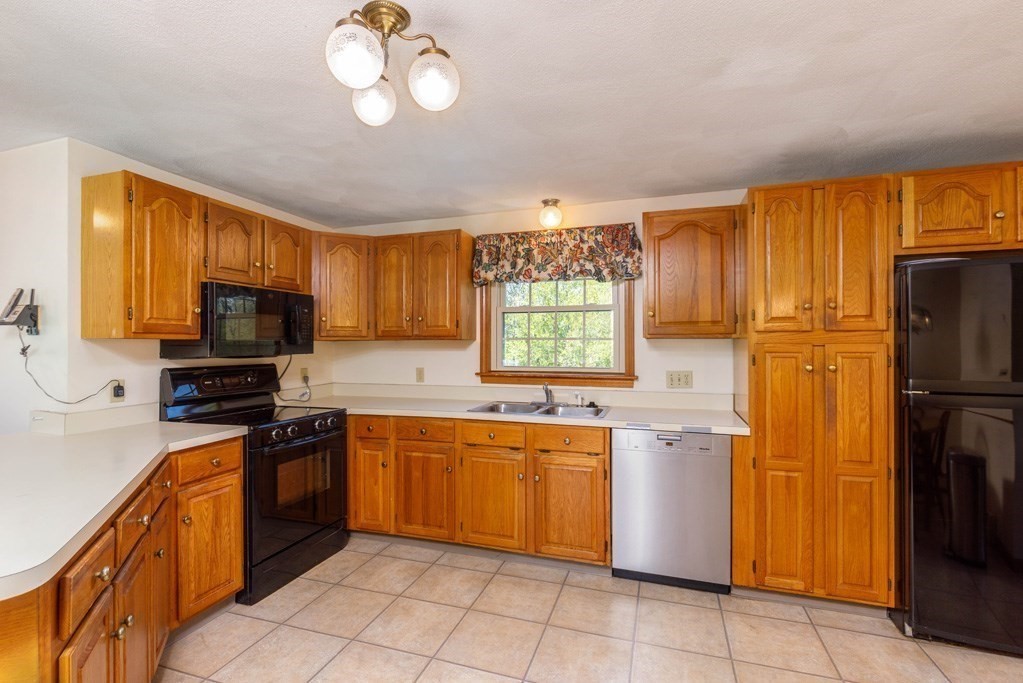 202 Leo Drive Gardner, MA 01440 - Photo 5 of 26 a kitchen with stainless steel appliances granite countertop a sink dishwasher stove top oven and refrigerator