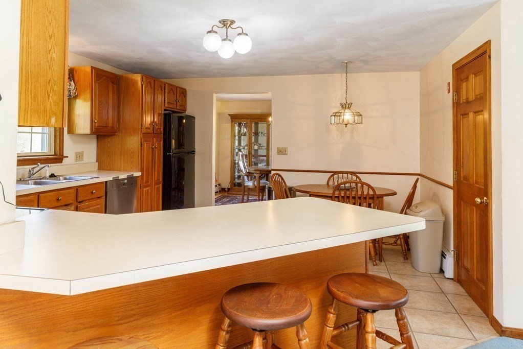 202 Leo Drive Gardner, MA 01440 - Photo 7 of 26 a view of kitchen island a sink chandelier and living room view