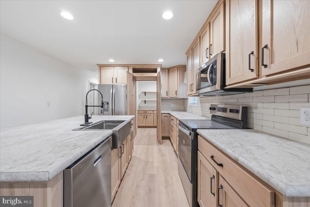 3987 Hastings Road Walnutport, PA 18088 - Photo 13 of 40 a kitchen with stainless steel appliances granite countertop a sink stove and cabinets