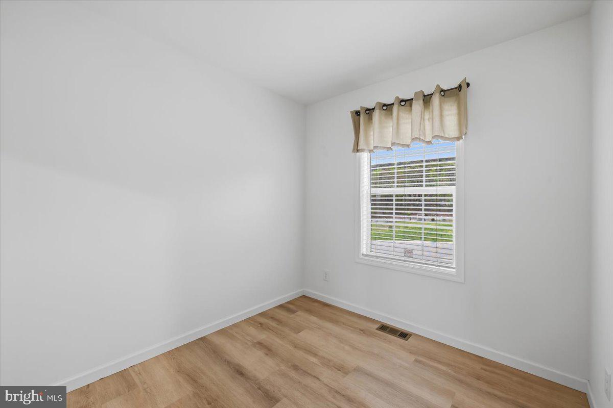 3987 Hastings Road Walnutport, PA 18088 - Photo 21 of 40 a view of an empty room with wooden floor and a window