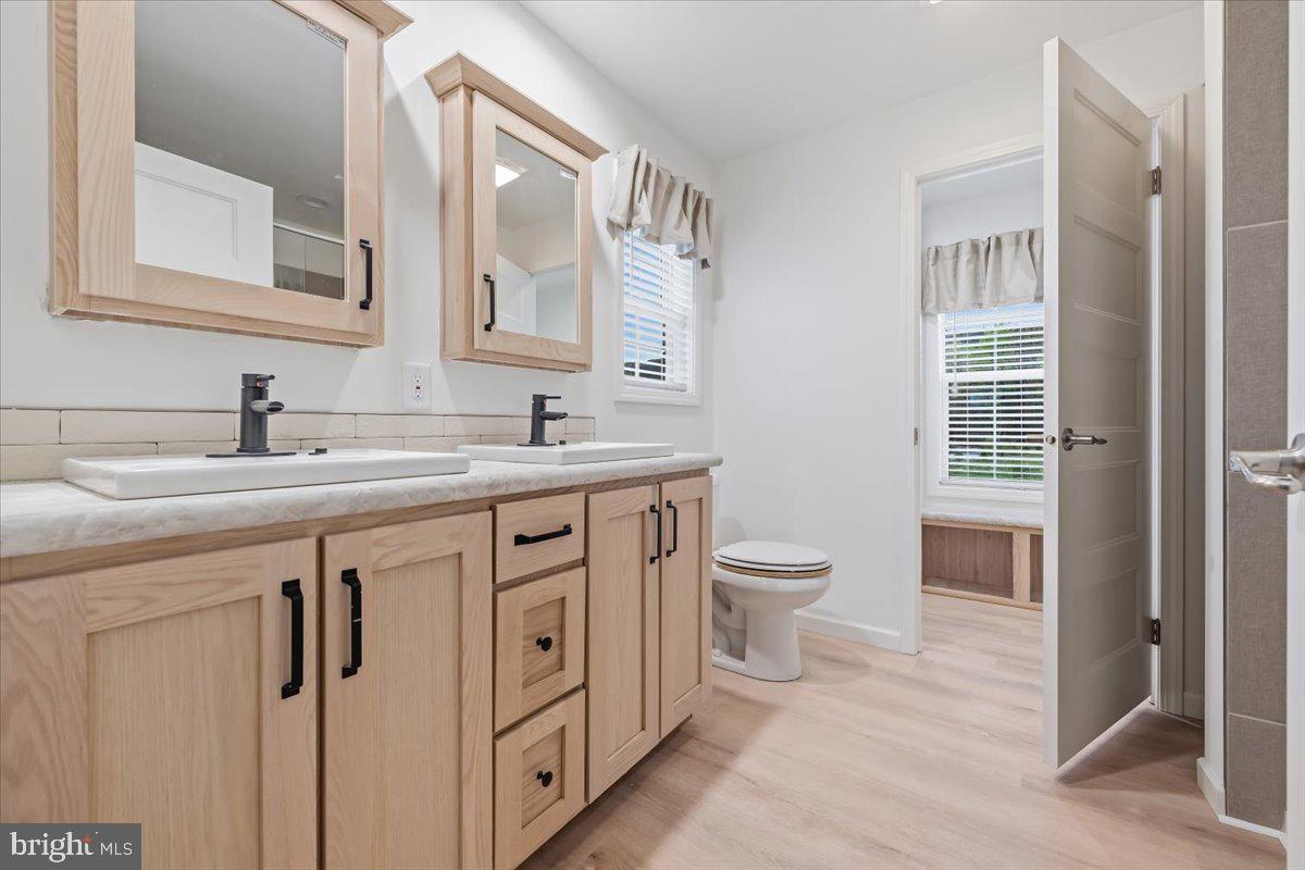 3987 Hastings Road Walnutport, PA 18088 - Photo 25 of 40 a spacious bathroom with a double vanity sink a toilet and a mirror