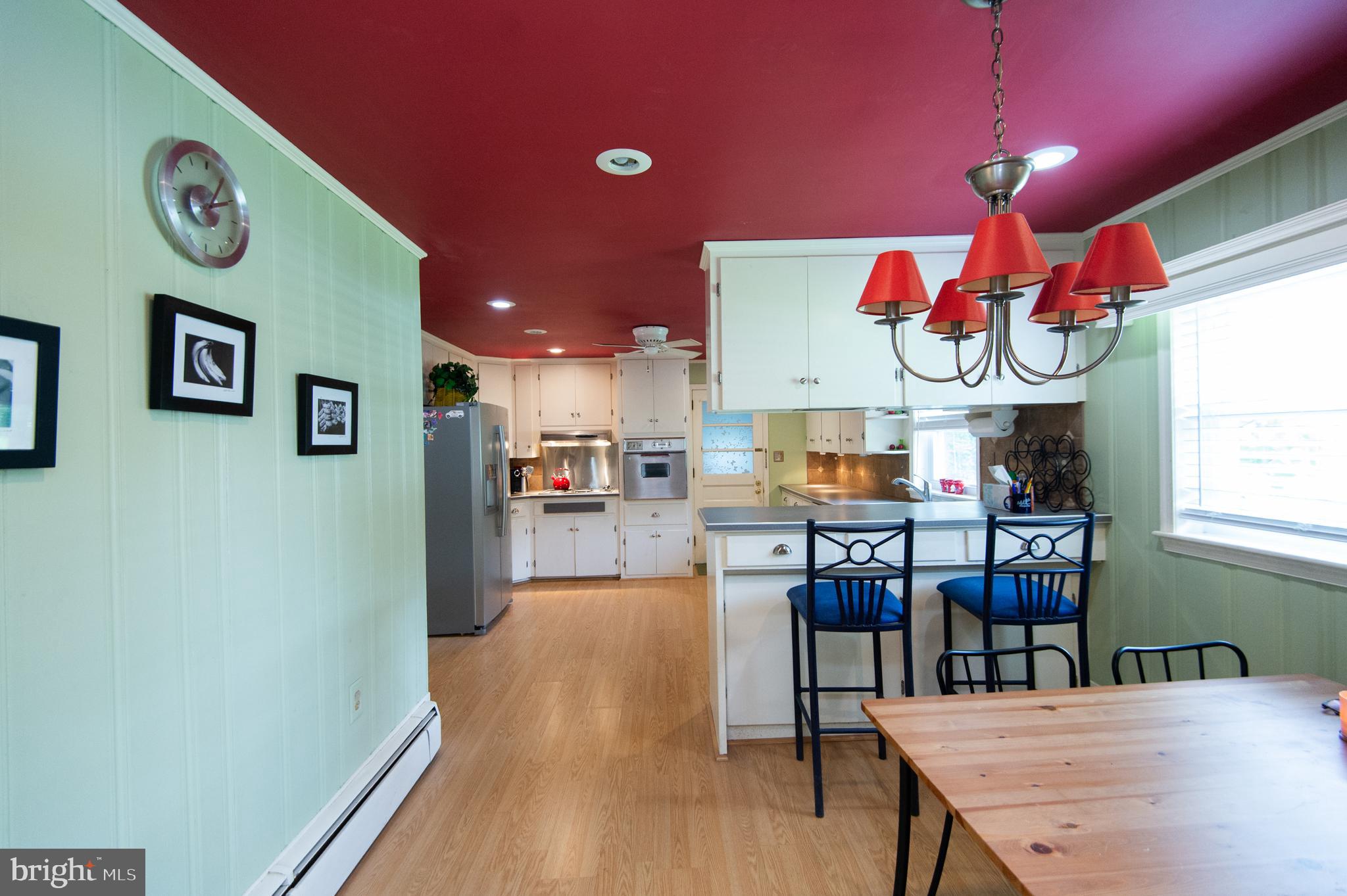 36 Algonquin Road Cambridge, MD 21613 - Photo 12 of 40 a kitchen with a wooden floor and a dining table