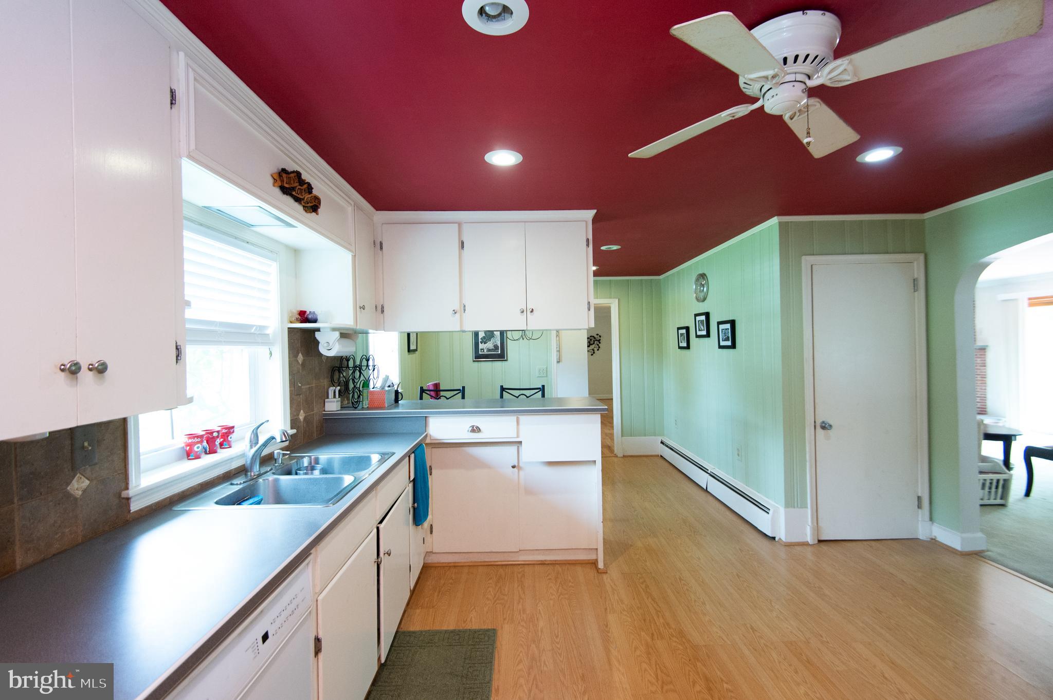 36 Algonquin Road Cambridge, MD 21613 - Photo 16 of 40 a kitchen with kitchen island granite countertop a sink cabinets and stainless steel appliances