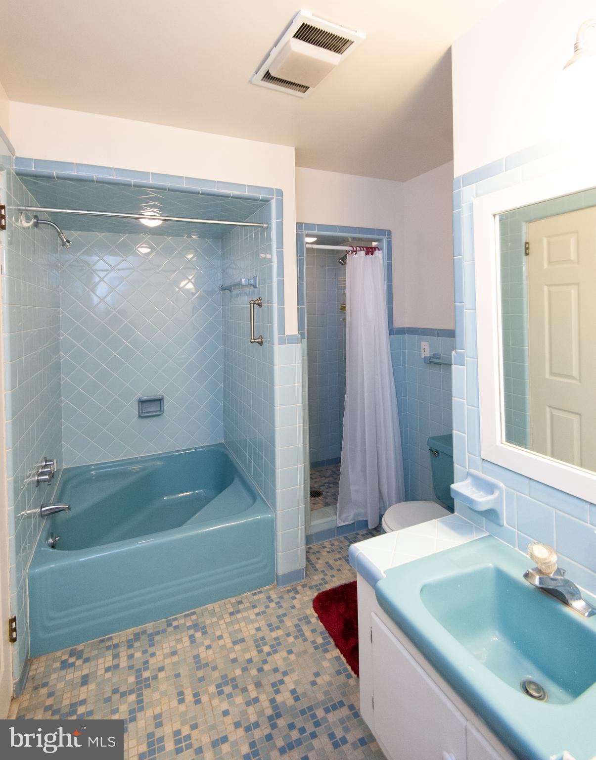36 Algonquin Road Cambridge, MD 21613 - Photo 26 of 40 a bathroom with a granite countertop sink a mirror and a bathtub