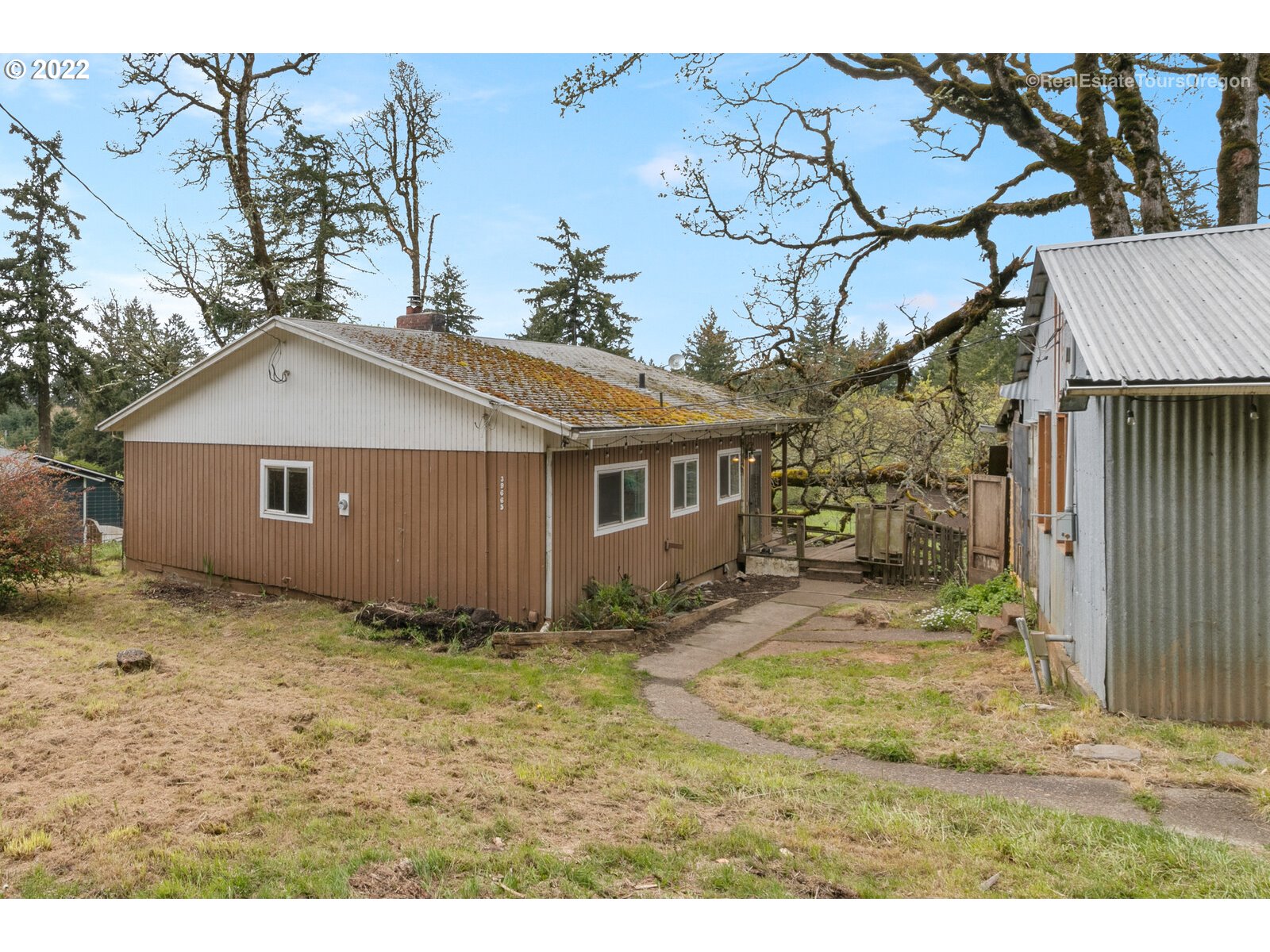 39665 Southwest Gibson Road Gaston, OR 97119 - Photo 1 of 29 a view of a yard in front of a house with large trees