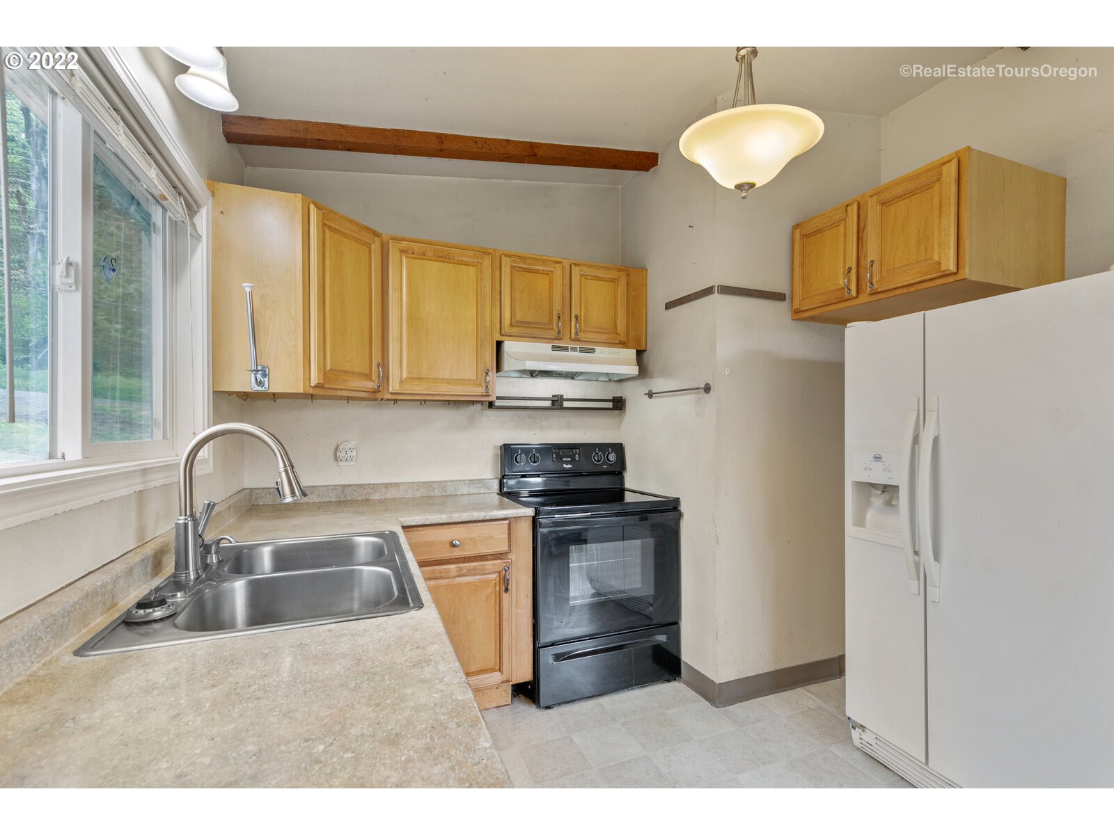 39665 Southwest Gibson Road Gaston, OR 97119 - Photo 18 of 29 a kitchen with stainless steel appliances granite countertop a sink a stove a refrigerator cabinets and a sink
