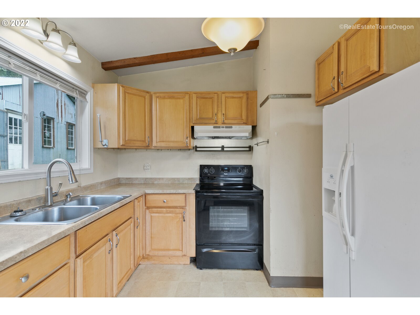 39665 Southwest Gibson Road Gaston, OR 97119 - Photo 26 of 29 a kitchen with a sink appliances and cabinets