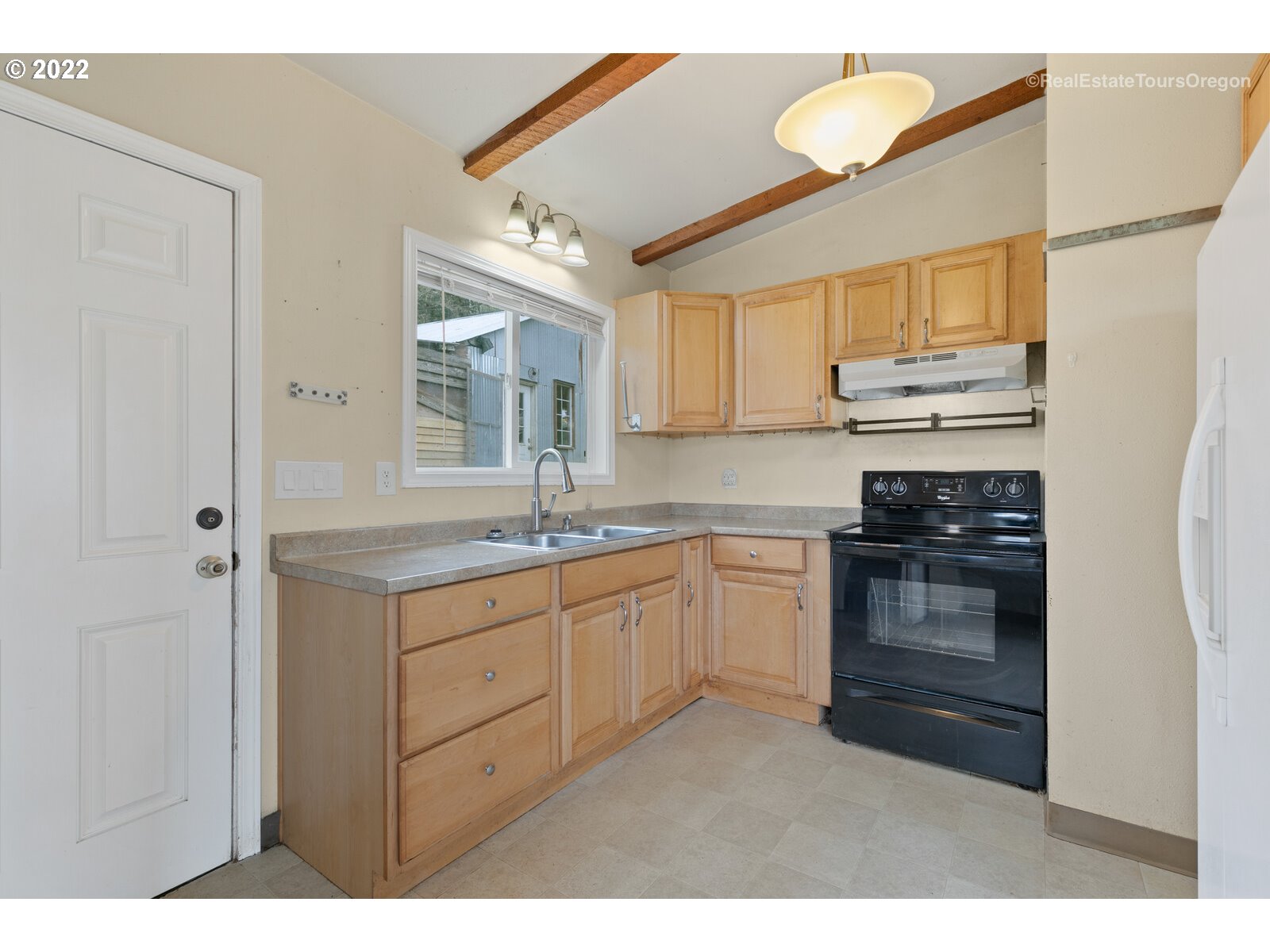 39665 Southwest Gibson Road Gaston, OR 97119 - Photo 27 of 29 a kitchen with granite countertop a sink cabinets stainless steel appliances and a window