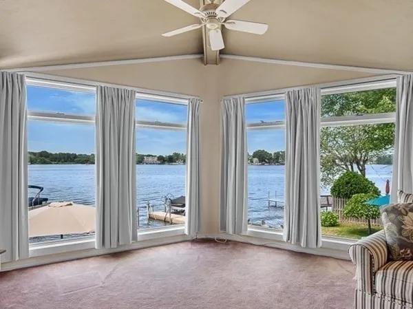 a view of a room with a large window and front door
