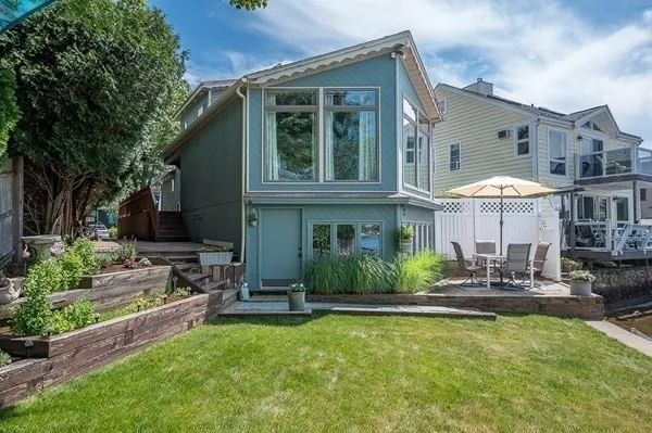 a front view of a house with a yard table and chairs