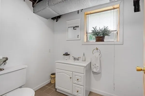 a bathroom with a sink vanity mirror and toilet