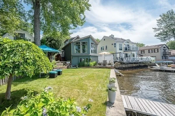 a view of a house with swimming pool next to a yard