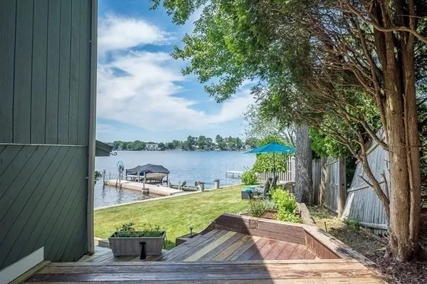 a wooden bench sitting next to a lake