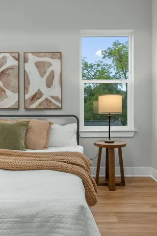 a bedroom with a bed and a window