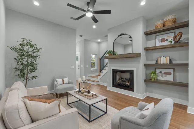 a living room with furniture and a fireplace