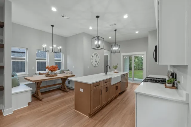 a kitchen with granite countertop a stove and a sink