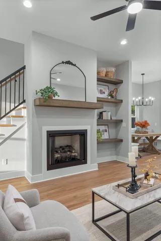 a view of a living room with a sink and wooden floor
