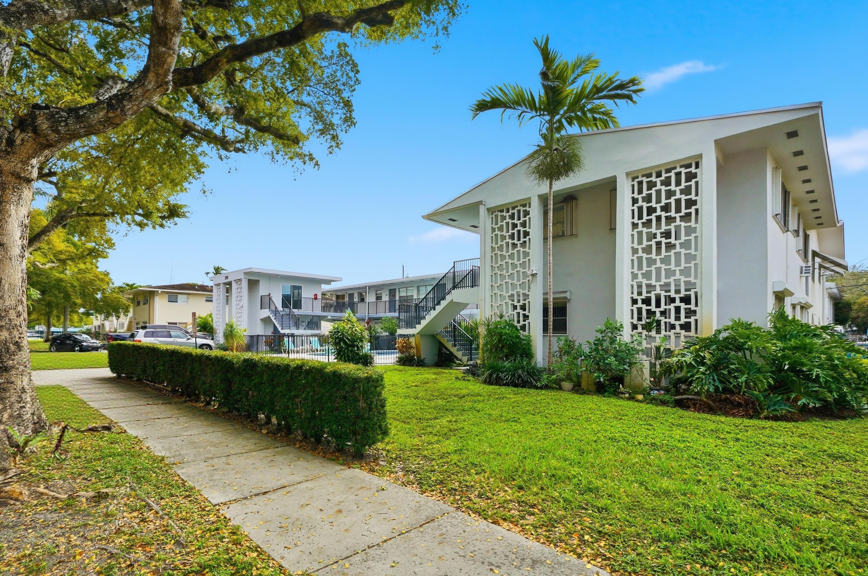 3510 Harrison Street, Unit 4 Hollywood, FL 33021 - Photo 2 of 31 a front view of a house with a yard and garage