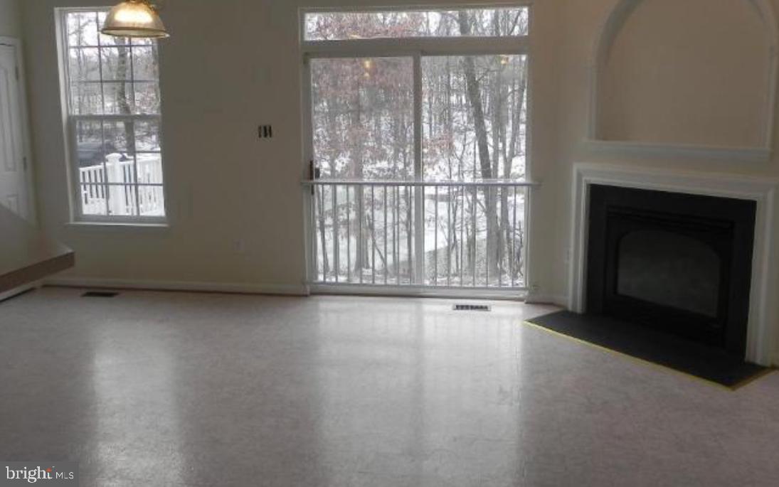 20118 Gunners Terrace Germantown, MD 20876 - Photo 9 of 12 an empty room with windows and fireplace