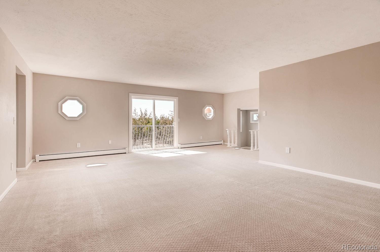 9907 Phillips Road Lafayette, CO 80026 - Photo 29 of 31 an empty room with windows