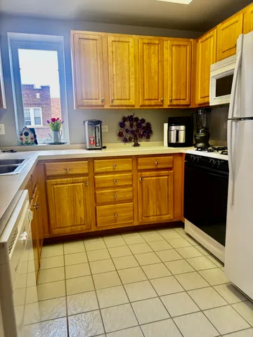 a view of a hallway with furniture and a bathroom