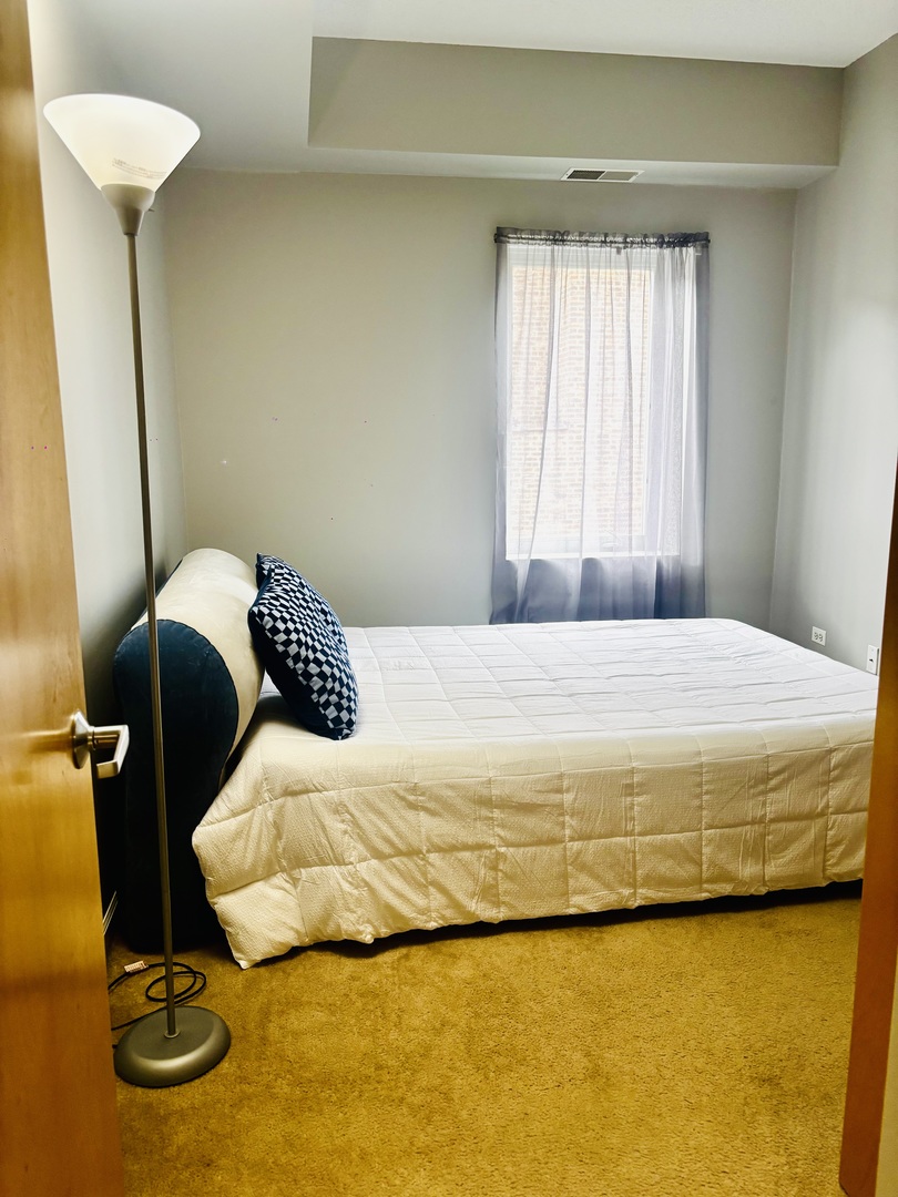 6238 West 26th Street, Unit 201 Berwyn, IL 60402 - Photo 13 of 30 a bedroom with a bed and a table