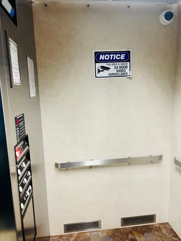 a view of kitchen with stainless steel appliances kitchen island a chandelier
