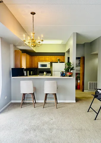 a room with a bed and a chandelier