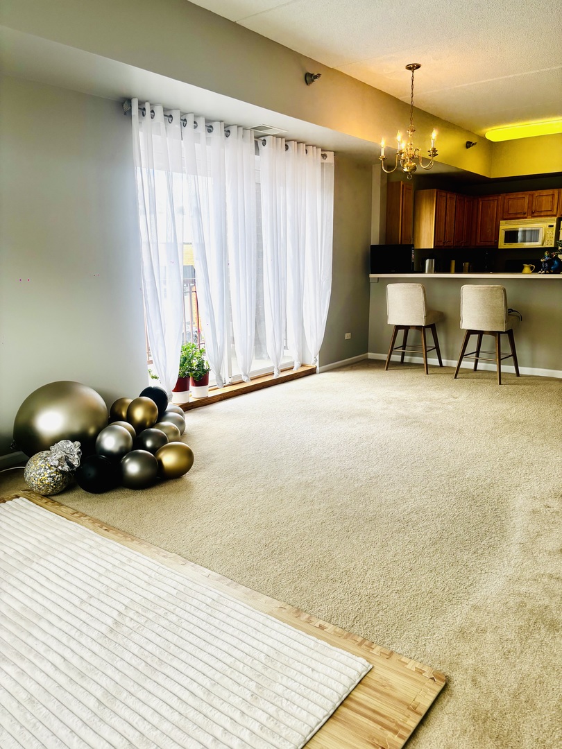 6238 West 26th Street, Unit 201 Berwyn, IL 60402 - Photo 9 of 30 a room with a bed and a chandelier