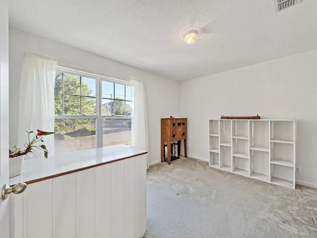 a living room with furniture a window and a chandelier