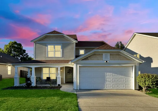 a front view of a house with a yard