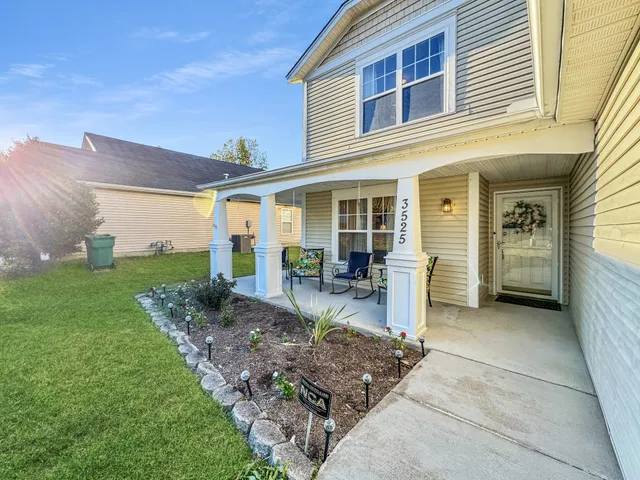 a view of a house with backyard porch and sitting area
