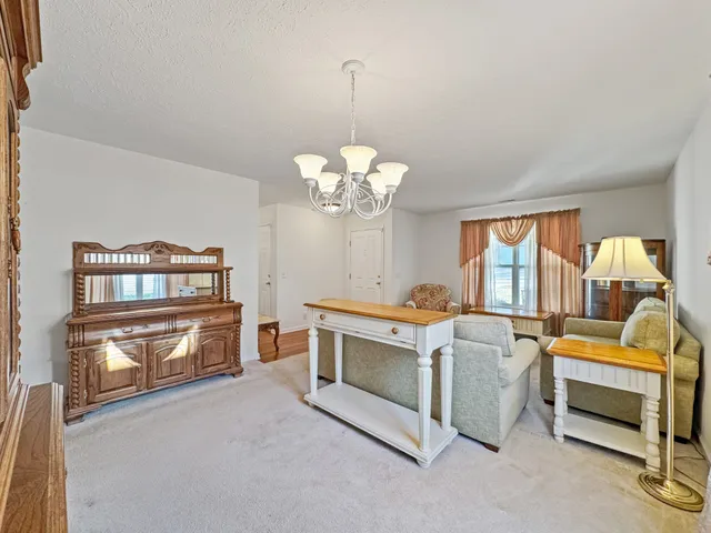 a living room with furniture and a chandelier