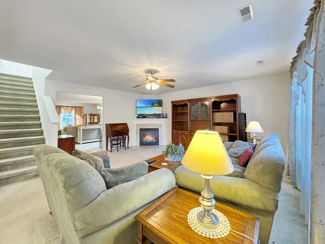 a living room with furniture and a lamp