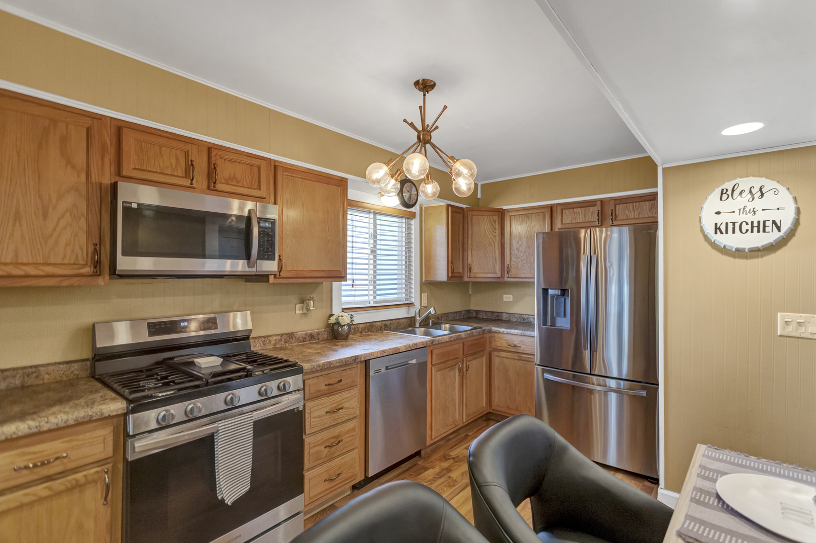 507 Monroe Road Bolingbrook, IL 60440 - Photo 11 of 29 a kitchen with stainless steel appliances granite countertop a stove a sink dishwasher a refrigerator and a microwave