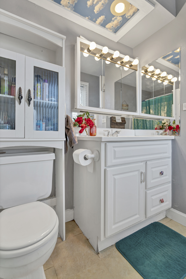 507 Monroe Road Bolingbrook, IL 60440 - Photo 17 of 29 a bathroom with a toilet sink and mirror