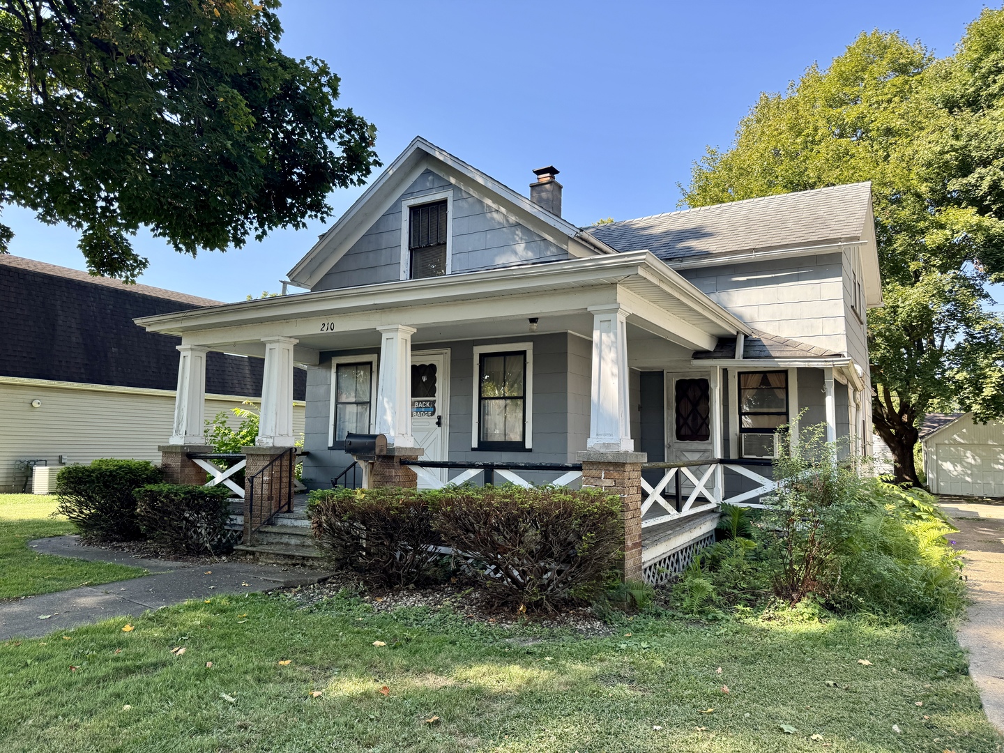 a front view of a house with a garden and porch