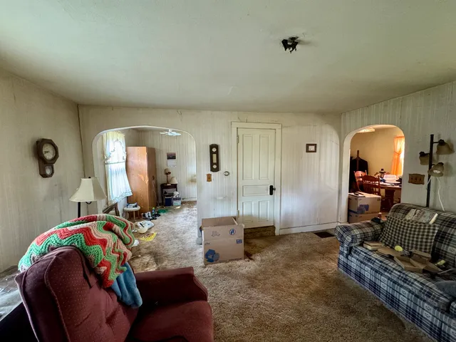 a living room with furniture and a mirror