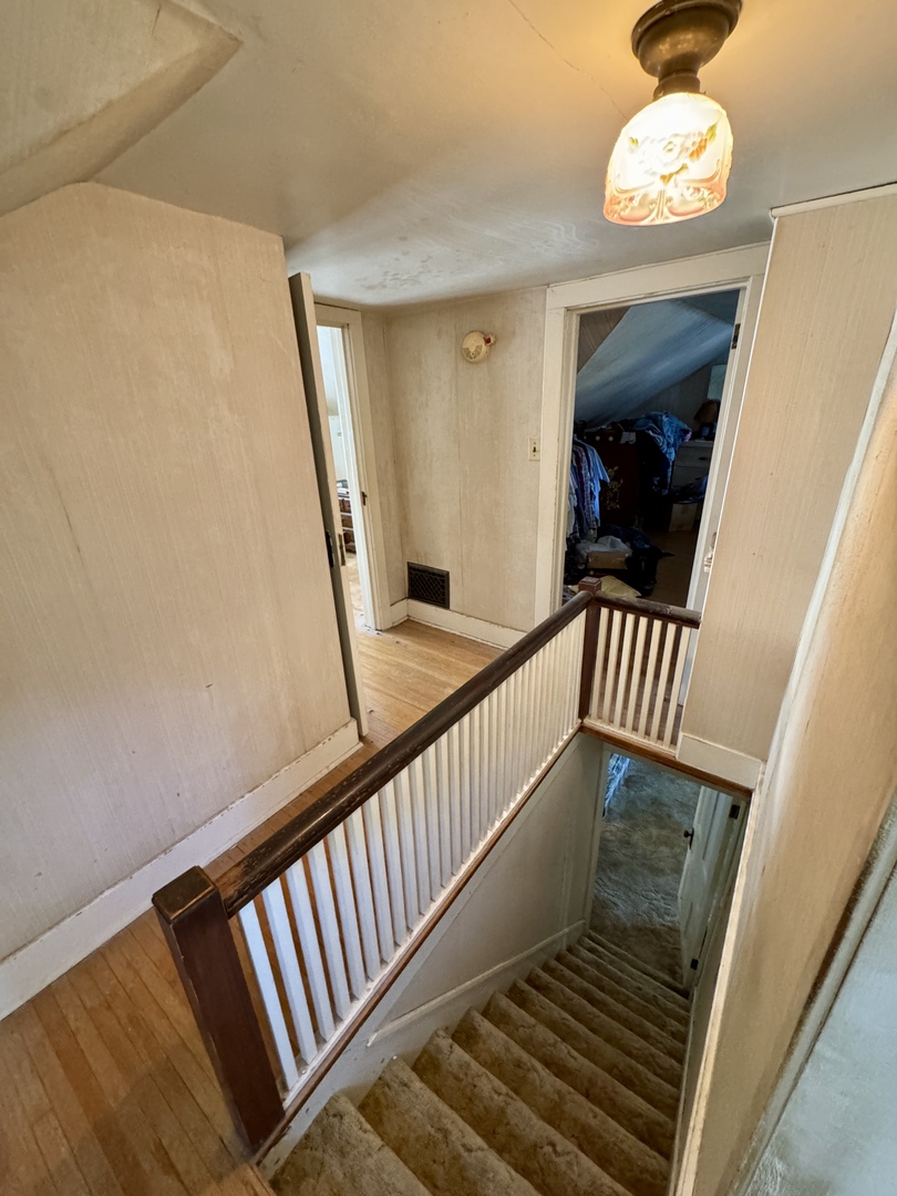 210 North Church Street Princeton, IL 61356 - Photo 9 of 20 a view of a hallway with wooden floor and stairs